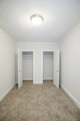 an empty room with closet area