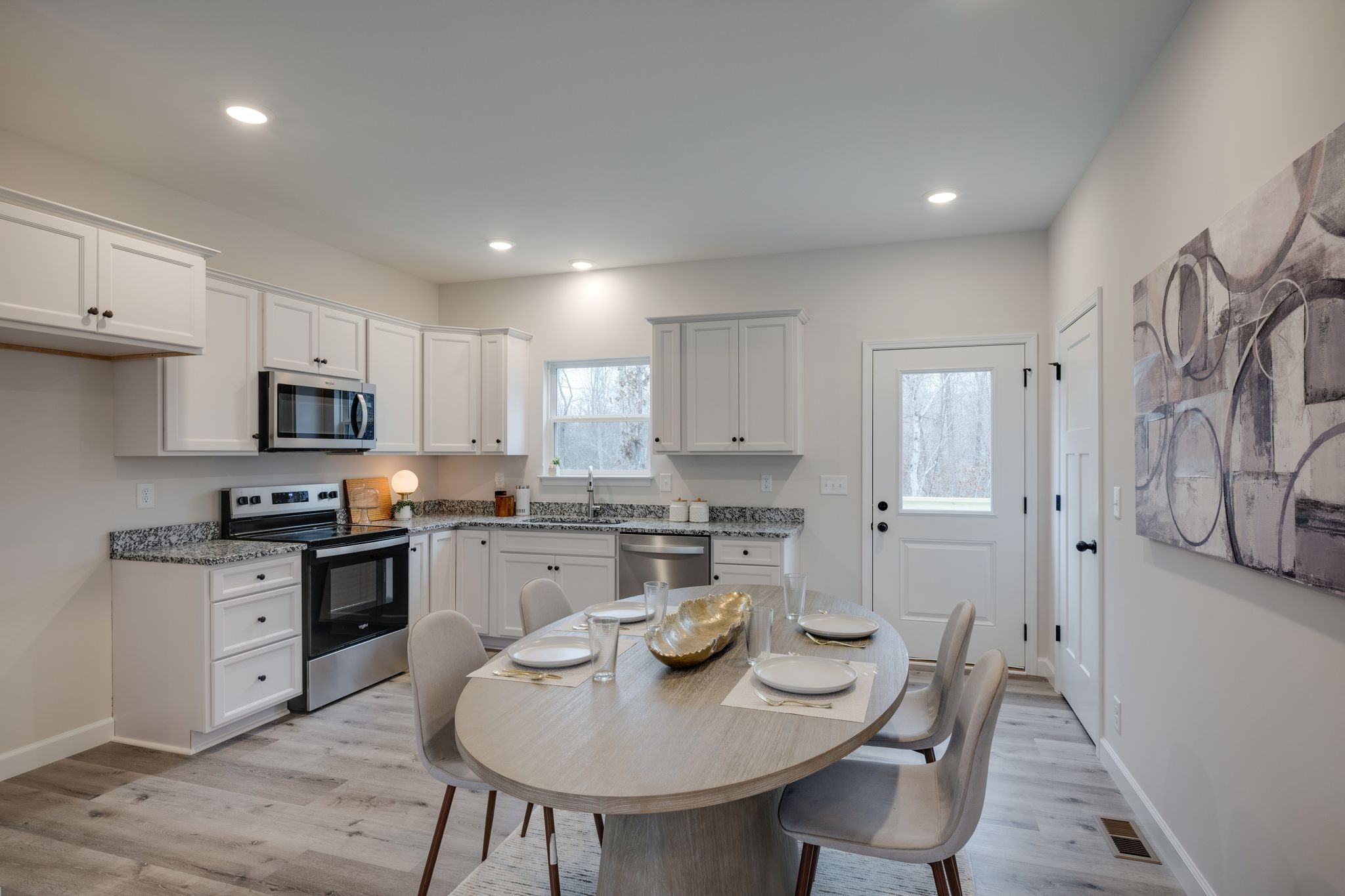 57 Truform Way Dickson, TN 37055 - Photo 10 of 29 a kitchen with stainless steel appliances granite countertop a stove top oven a sink a stove a dining table and chairs