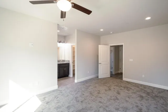a view of an empty room with a bathroom