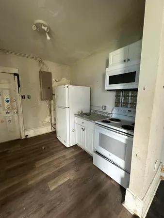 a kitchen with granite countertop a stove and a refrigerator
