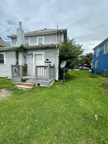 a view of a house with a yard porch and sitting area