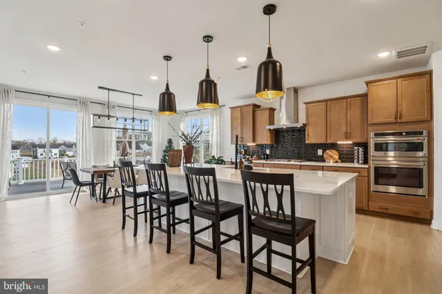 a spacious bedroom with a large bed and a chandelier