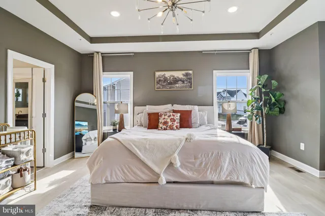 a bedroom with a large bed and a large window