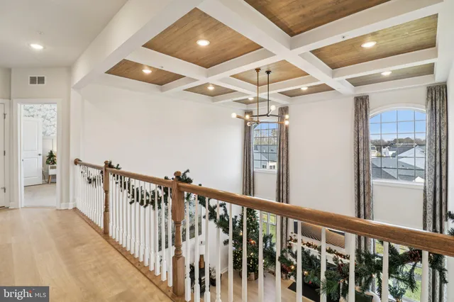a living room with furniture a chandelier and a dining table