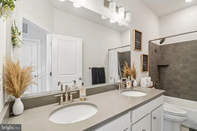an aerial view of a house with a yard basket ball court and outdoor seating