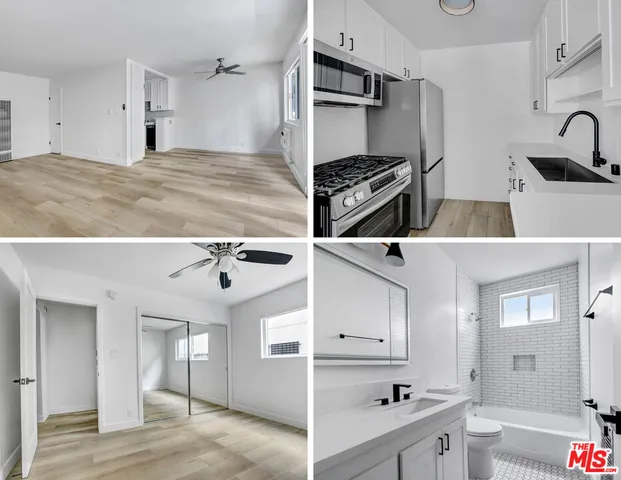 a view of kitchen with kitchen island a sink stainless steel appliances and cabinets