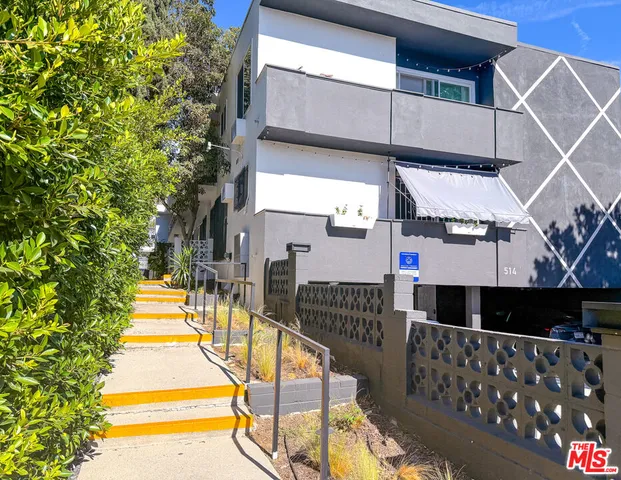 a balcony with table and chairs