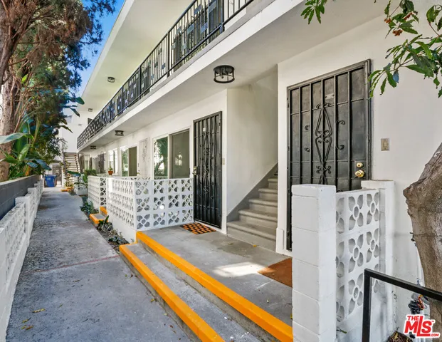 a view of kitchen with center island wooden floor and stainless steel appliances