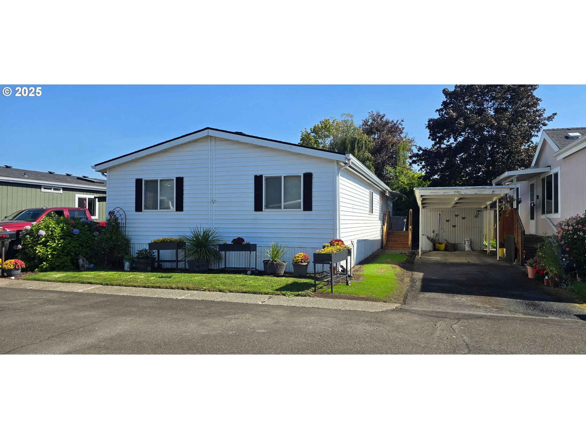 835 Southeast 1st Avenue, Unit 64 Canby, OR 97013 - Photo 1 of 37 a front view of a house with a yard and garage