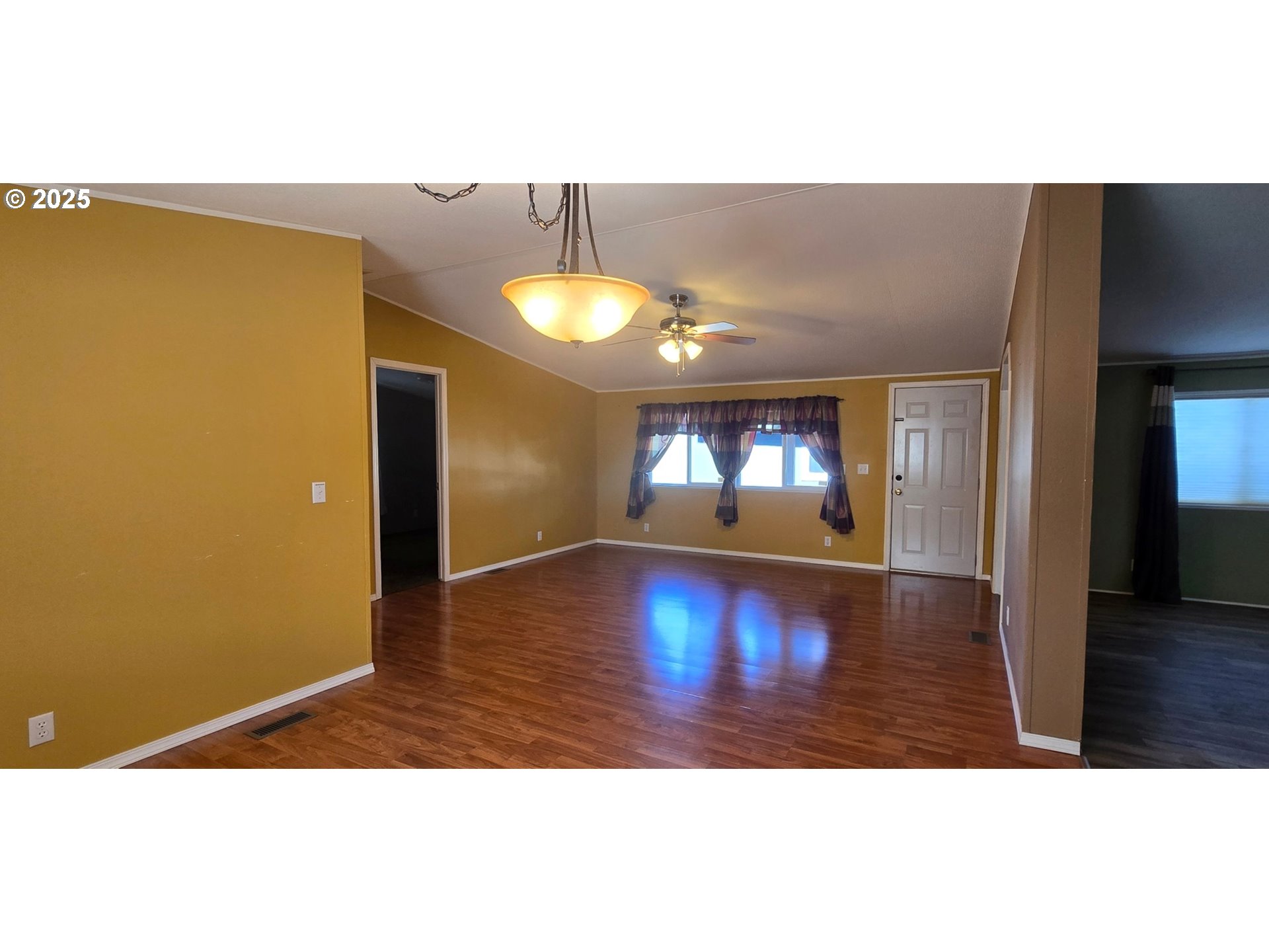 835 Southeast 1st Avenue, Unit 64 Canby, OR 97013 - Photo 16 of 37 a view of an empty room with wooden floor and a window