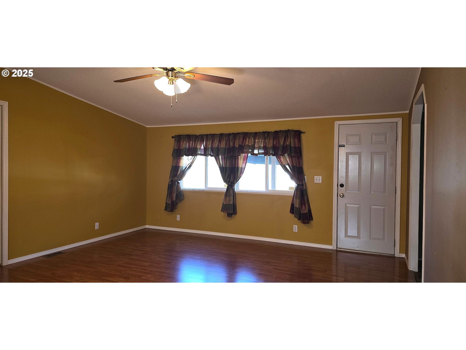 835 Southeast 1st Avenue, Unit 64 Canby, OR 97013 - Photo 18 of 37 a view of empty room with wooden floor and fan