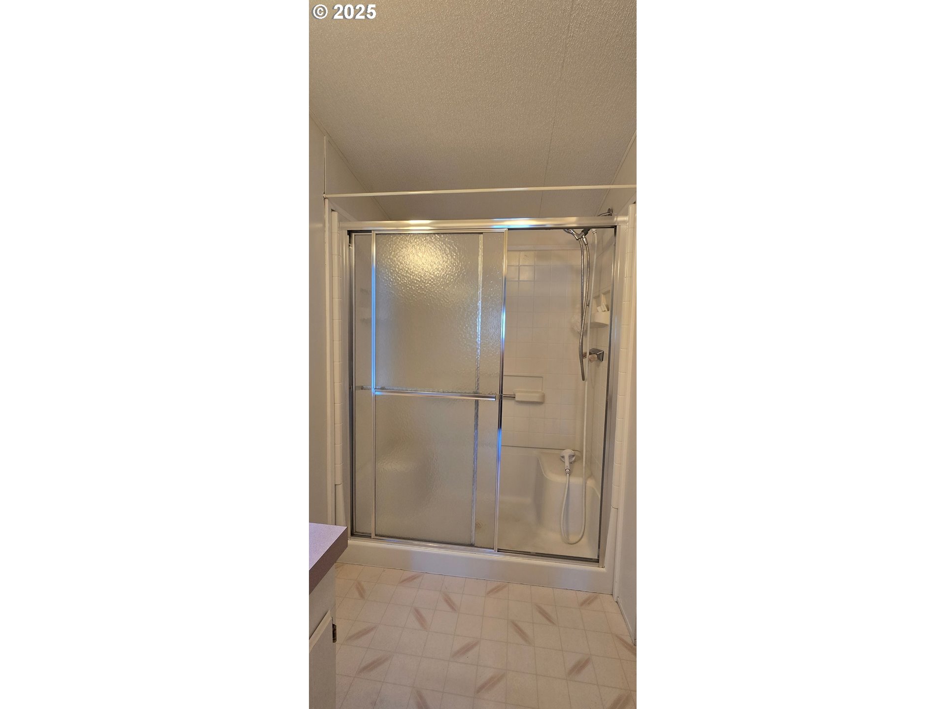 835 Southeast 1st Avenue, Unit 64 Canby, OR 97013 - Photo 24 of 37 a bathroom with a glass shower door
