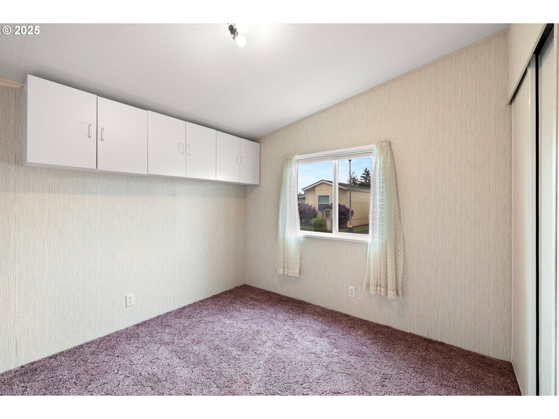 835 Southeast 1st Avenue, Unit 64 Canby, OR 97013 - Photo 32 of 37 a view of an empty room with a window