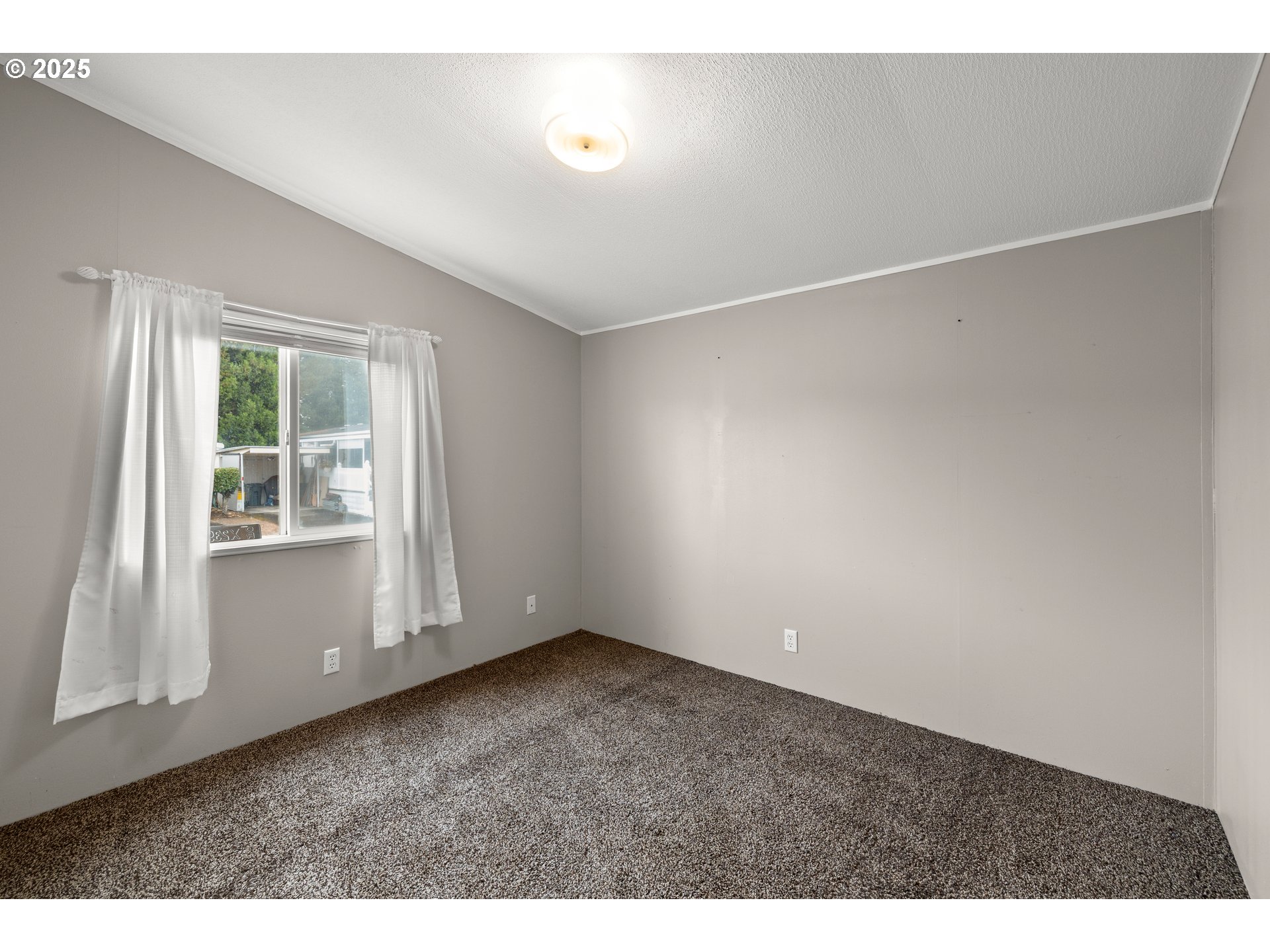 835 Southeast 1st Avenue, Unit 64 Canby, OR 97013 - Photo 33 of 37 a view of an empty room with a window