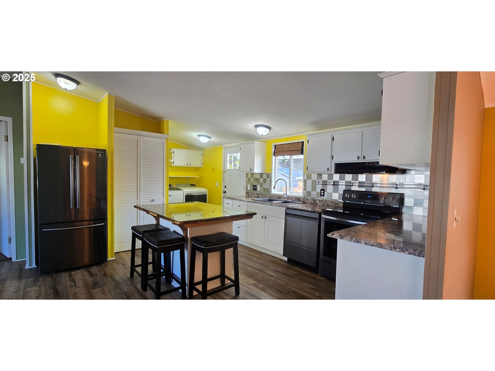 835 Southeast 1st Avenue, Unit 64 Canby, OR 97013 - Photo 4 of 37 a kitchen with stainless steel appliances kitchen island granite countertop a refrigerator a stove a sink a dining table and chairs