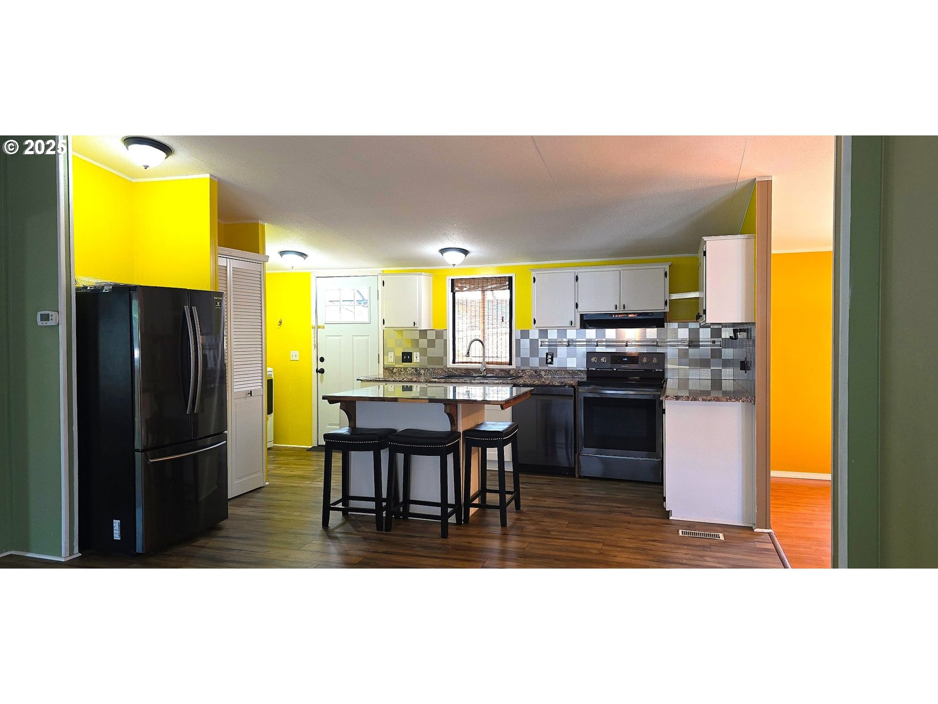 835 Southeast 1st Avenue, Unit 64 Canby, OR 97013 - Photo 9 of 37 a kitchen with a table and refrigerator