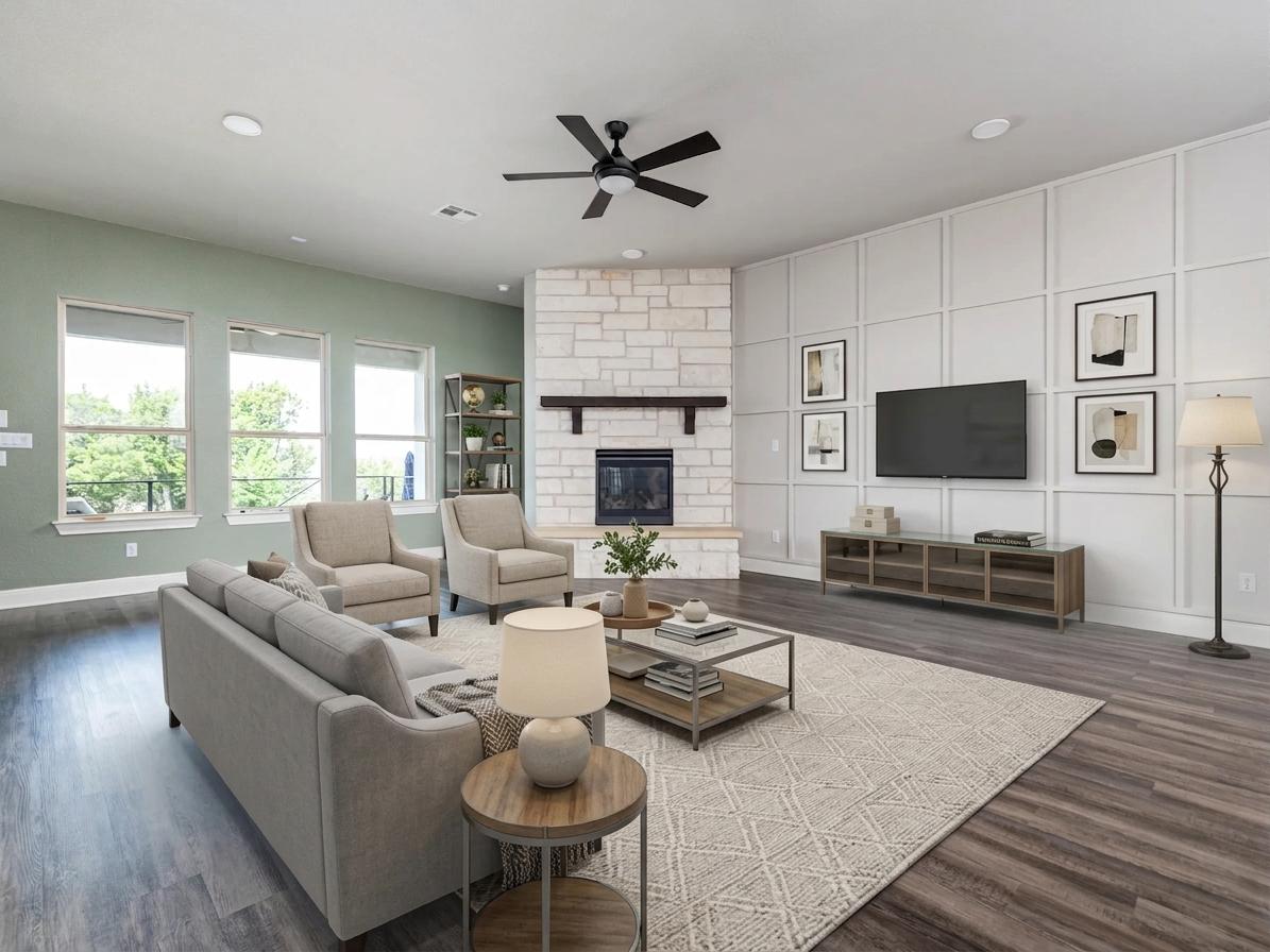 1329 Siena Sunset Road Leander, TX 78641 - Photo 12 of 40 A striking stone fireplace anchors this living space, offering warmth and a modern aesthetic.