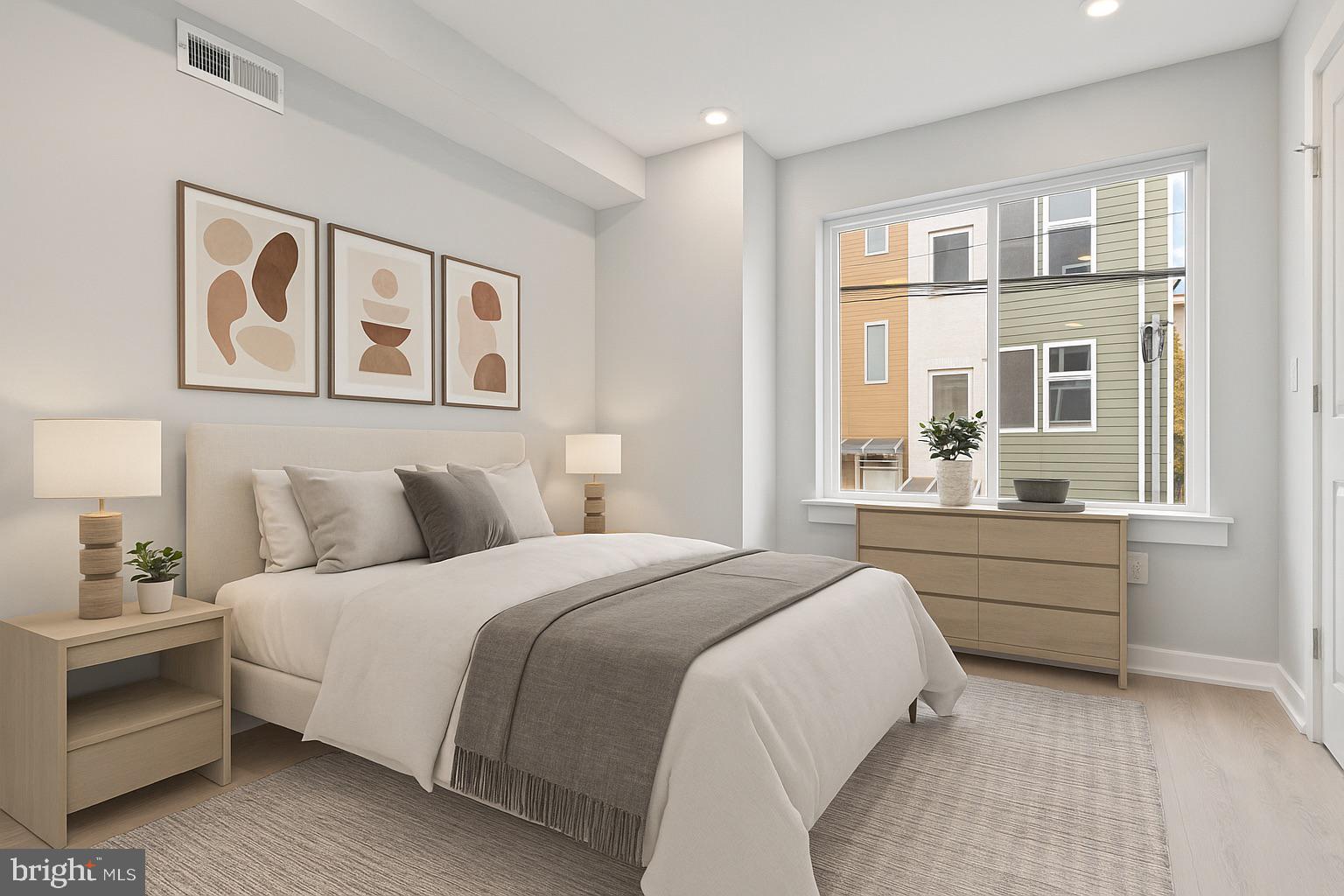 1432 Ogden Street, Unit 2 Philadelphia, PA 19130 - Photo 13 of 16 a spacious bedroom with a bed and a window