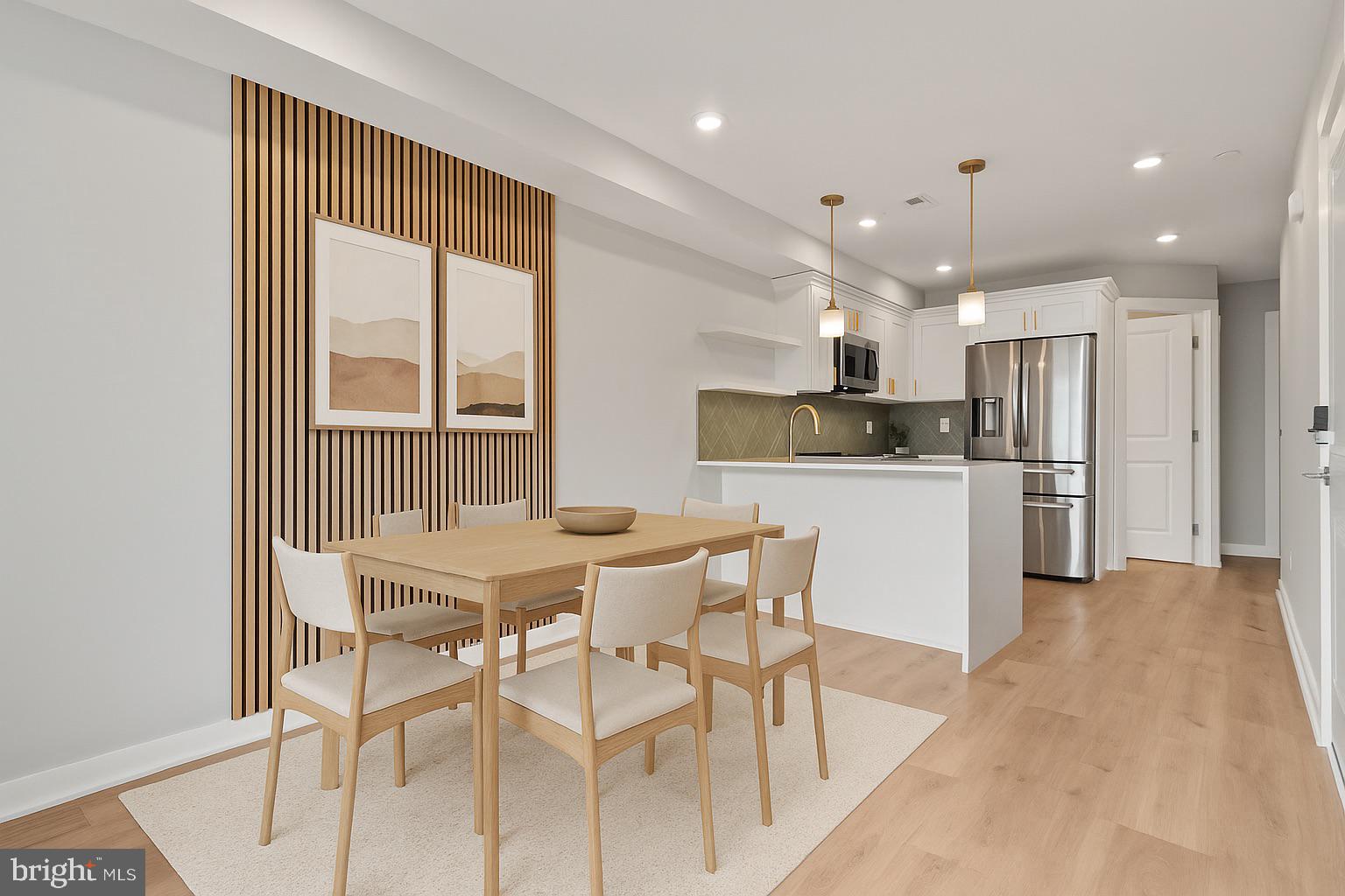 1432 Ogden Street, Unit 2 Philadelphia, PA 19130 - Photo 3 of 16 a kitchen with stainless steel appliances kitchen island granite countertop a refrigerator and microwave