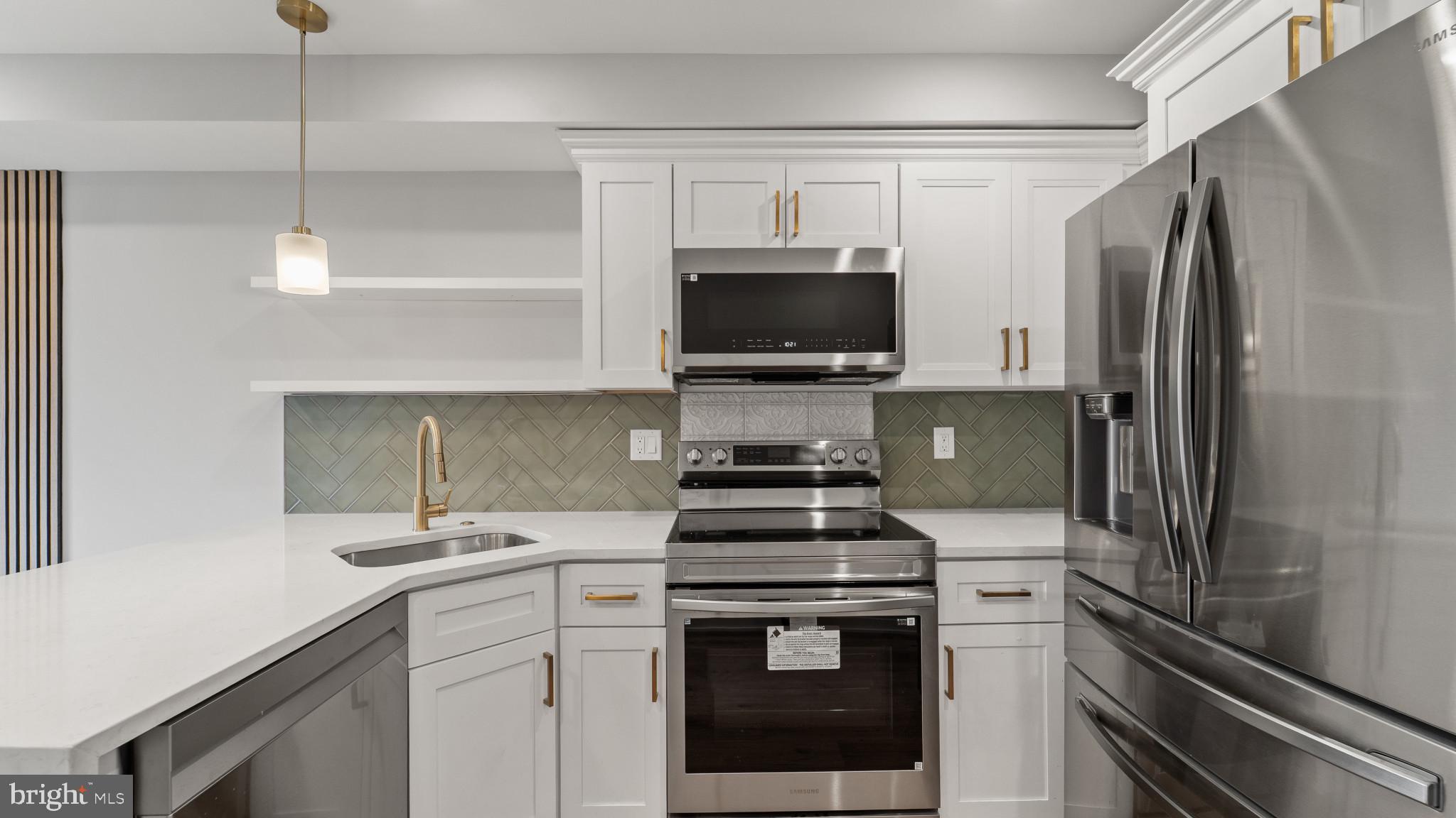 1432 Ogden Street, Unit 2 Philadelphia, PA 19130 - Photo 6 of 16 a kitchen with a sink appliances and cabinets