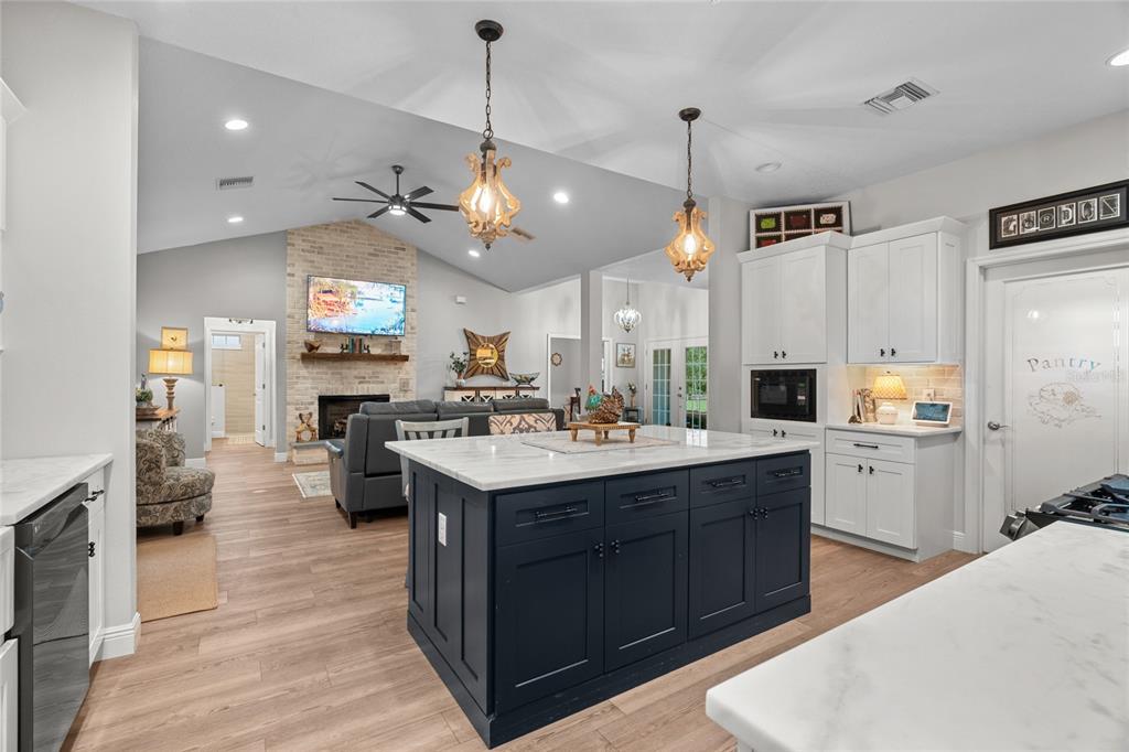 21679 Southwest 106th Lane Road Dunnellon, FL 34431 - Photo 19 of 88 a kitchen with kitchen island granite countertop a sink a stove and a refrigerator