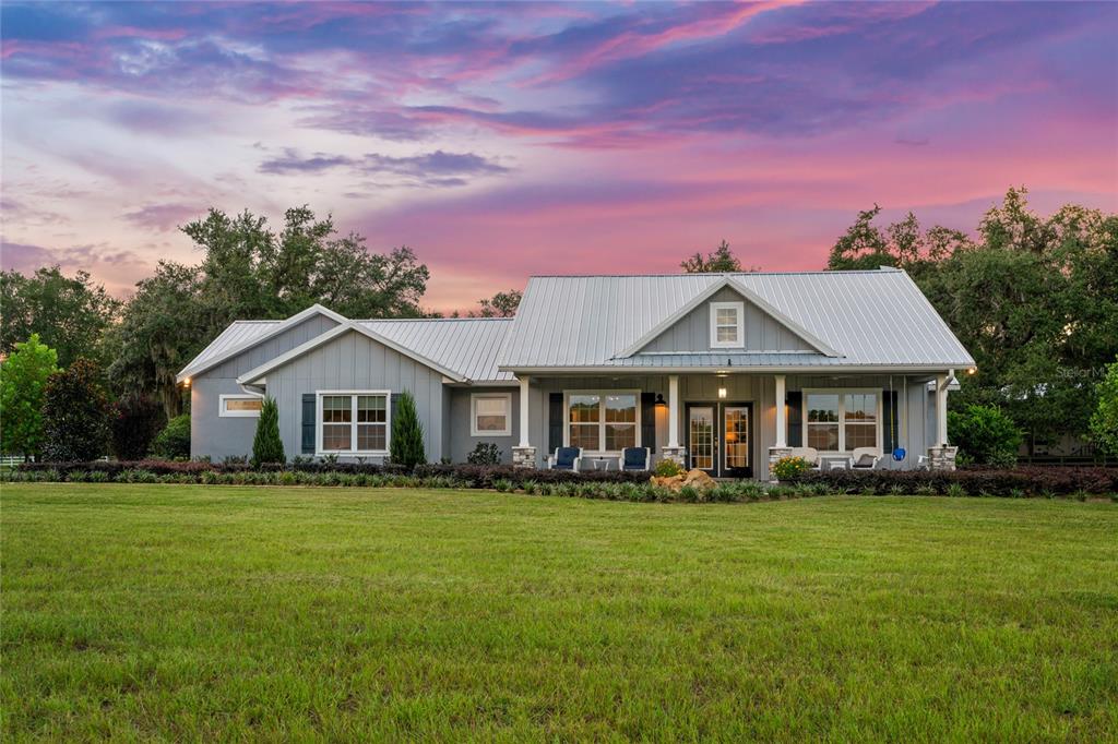 21679 Southwest 106th Lane Road Dunnellon, FL 34431 - Photo 2 of 88 a front view of a house with a garden
