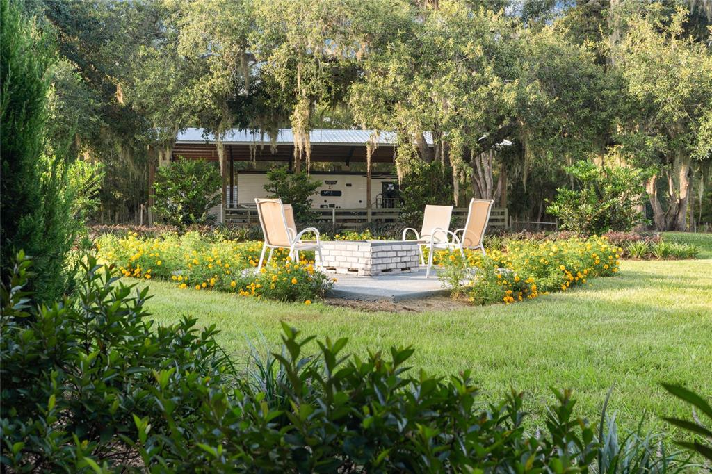 21679 Southwest 106th Lane Road Dunnellon, FL 34431 - Photo 47 of 88 a view of a chair and table of the garden