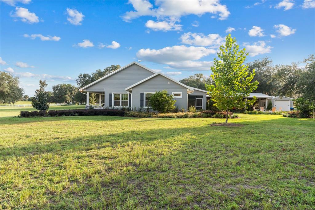 21679 Southwest 106th Lane Road Dunnellon, FL 34431 - Photo 67 of 88 a front view of house with yard swimming pool and green space