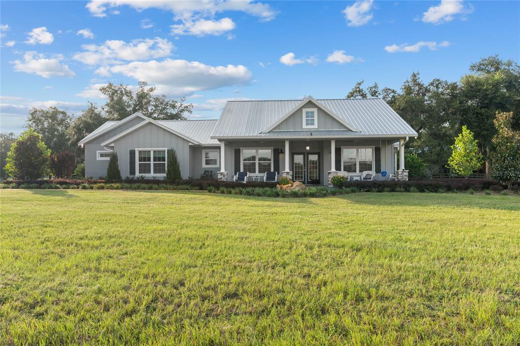 21679 Southwest 106th Lane Road Dunnellon, FL 34431 - Photo 77 of 88 a front view of a house with a garden