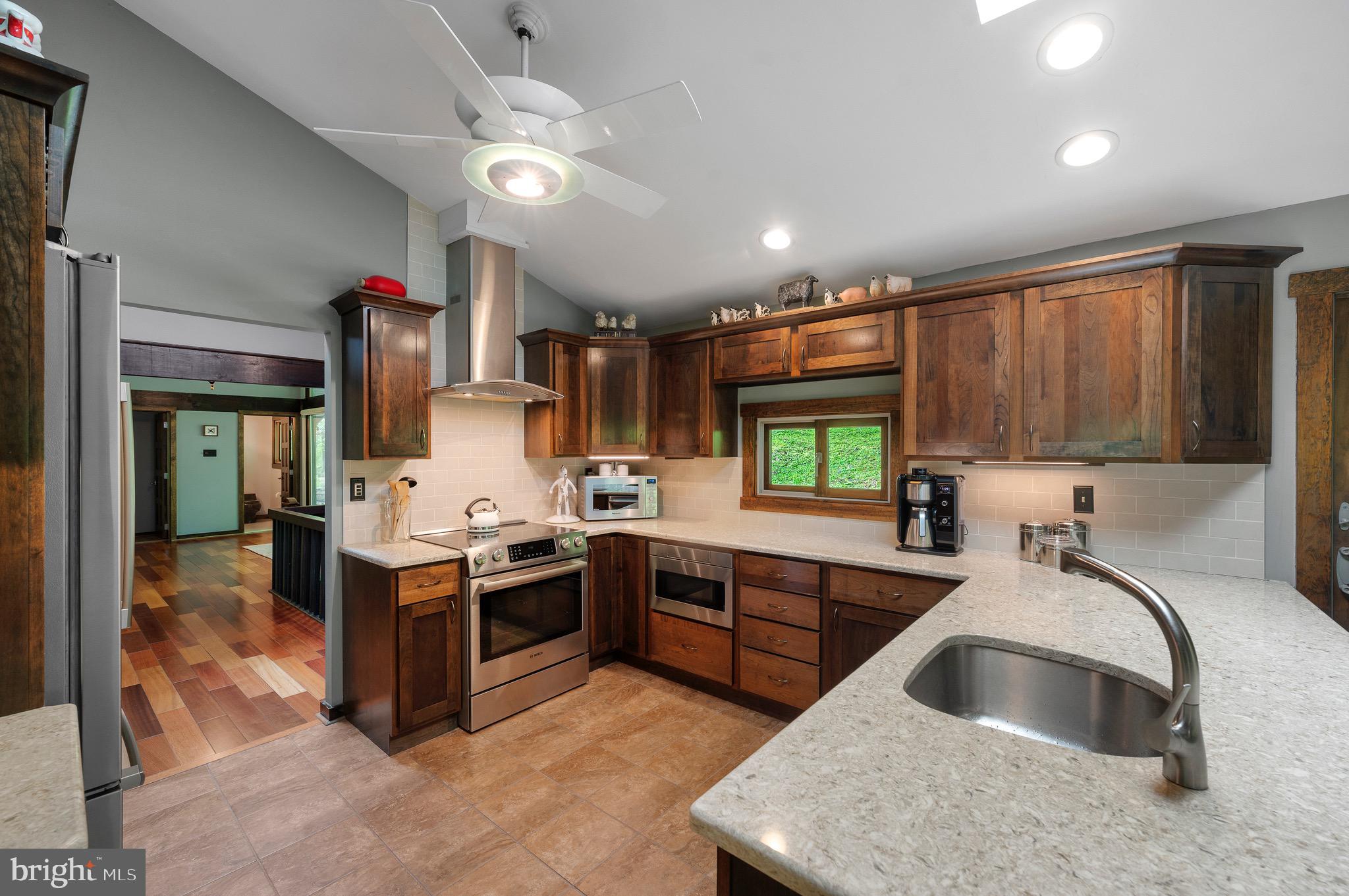 813 Old State Road Berwyn, PA 19312 - Photo 32 of 64 a kitchen with stainless steel appliances granite countertop a sink and a stove