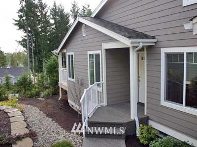 160 East Soderberg Road, Unit K30 Allyn, WA 98524 - Photo 1 of 1 a view of wooden house with a small yard and wooden fence