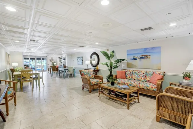 a living room with lots of furniture and lots of painting on the wall