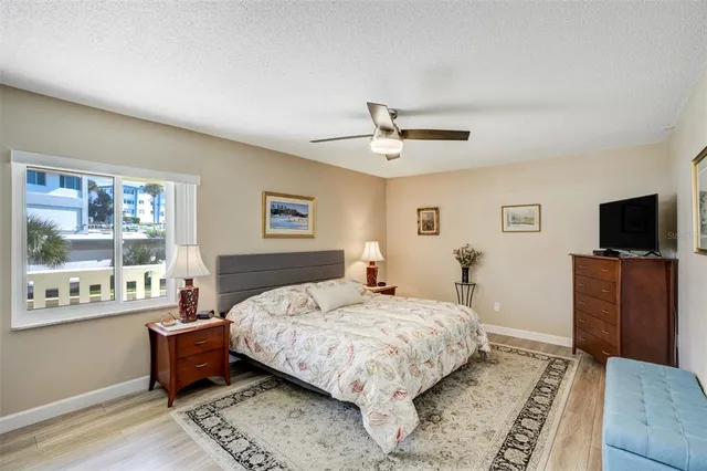 a bedroom with a large bed and a tv