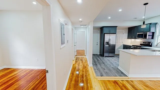 a view of kitchen with sink and refrigerator