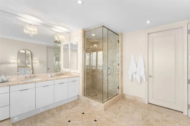 a bedroom with a bed wooden floor and large windows