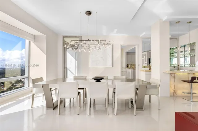 a large kitchen with lots of counter space and furniture