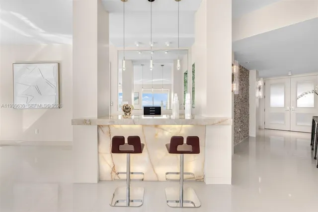 a kitchen with a dining table chairs and white cabinets