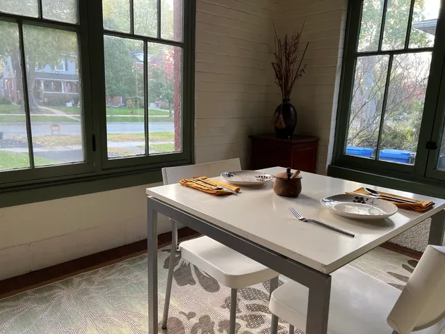 a dining room with furniture and window