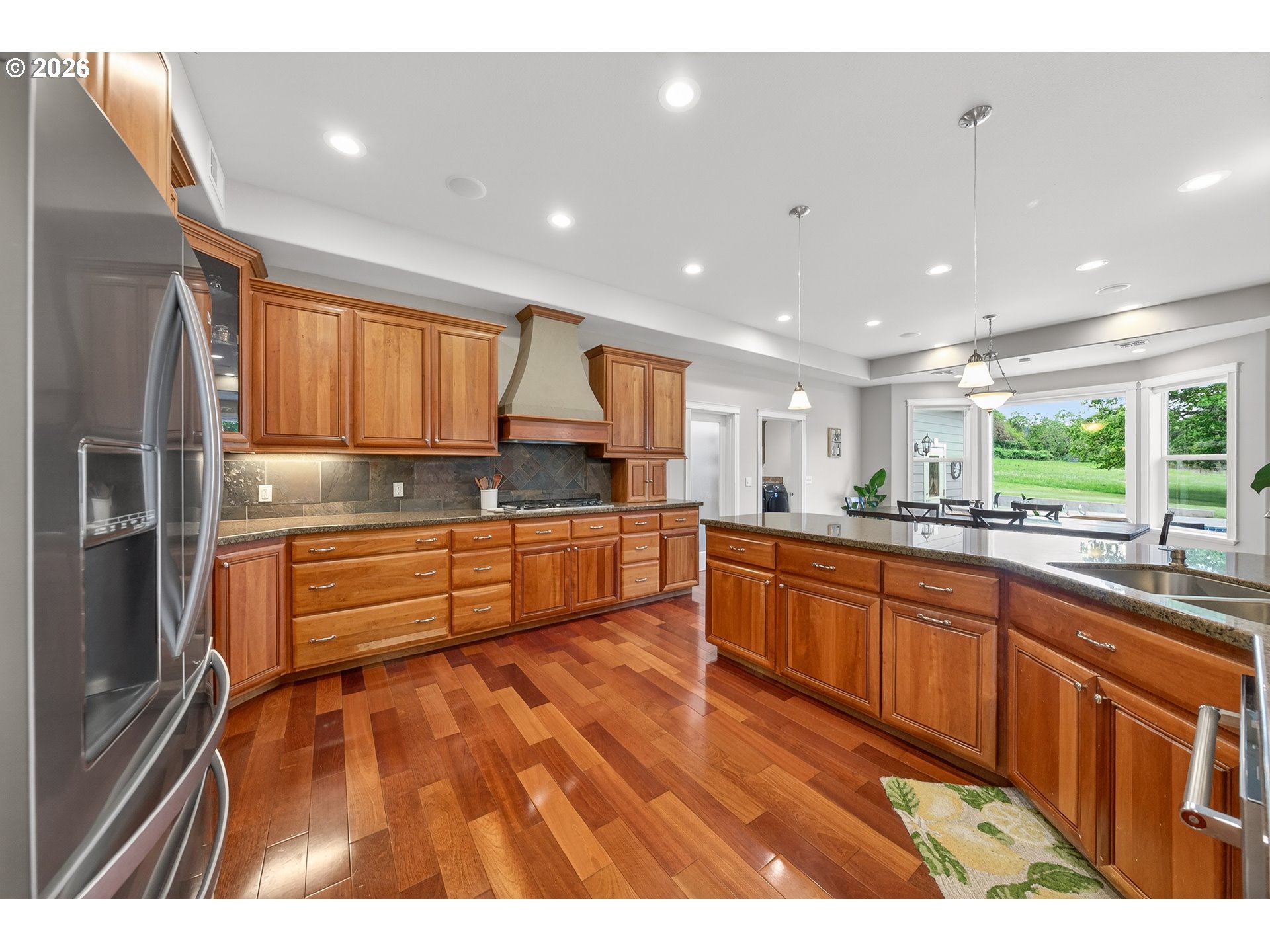 2700 Melrose Road Roseburg, OR 97471 - Photo 11 of 48 a large kitchen with kitchen island a sink stainless steel appliances and cabinets