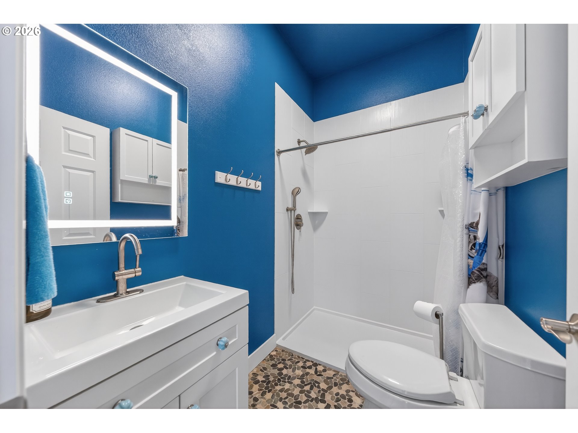 2700 Melrose Road Roseburg, OR 97471 - Photo 32 of 48 a bathroom with a sink a toilet a mirror and shower