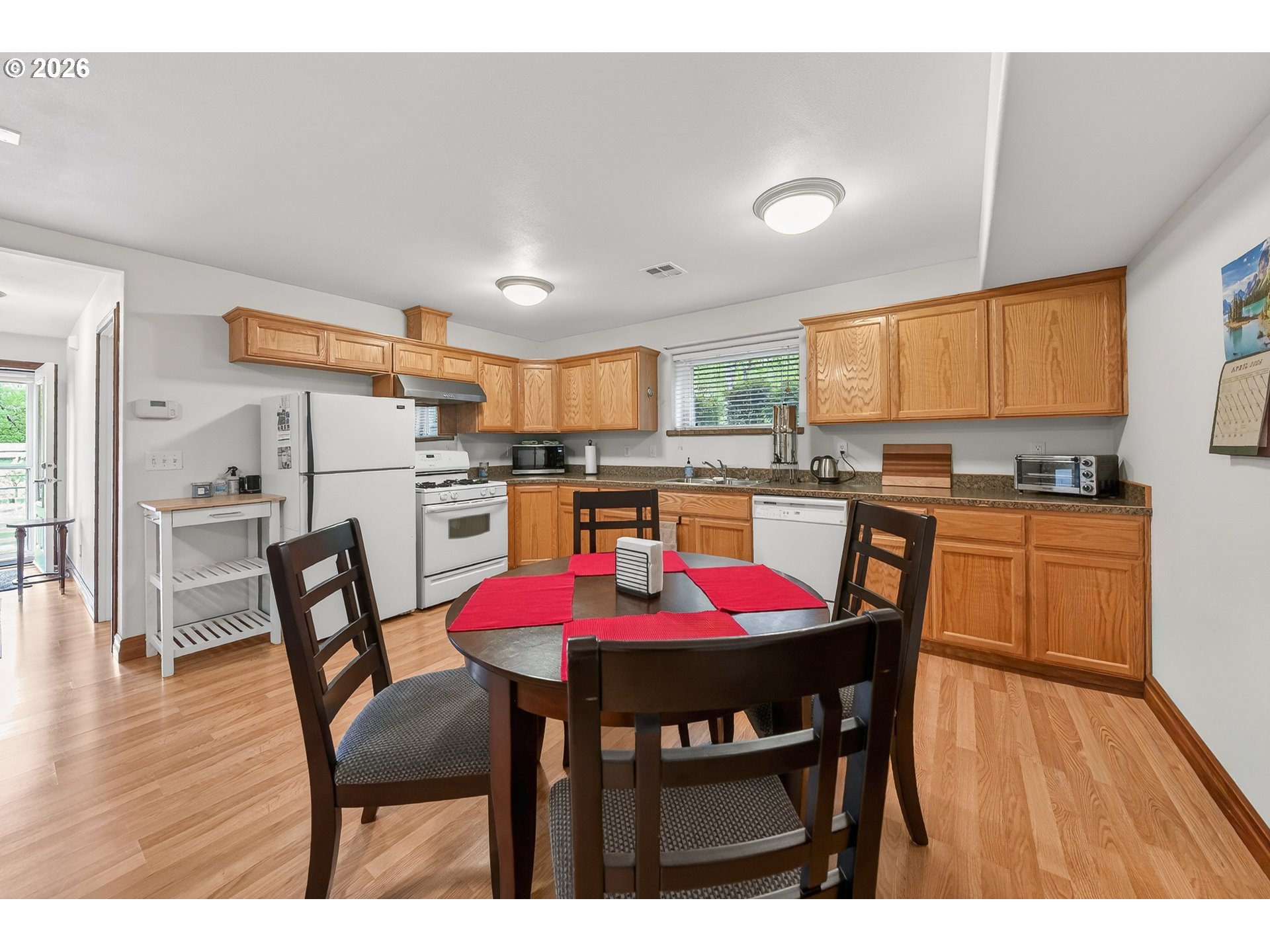 2700 Melrose Road Roseburg, OR 97471 - Photo 34 of 48 a kitchen with a dining table chairs and refrigerator