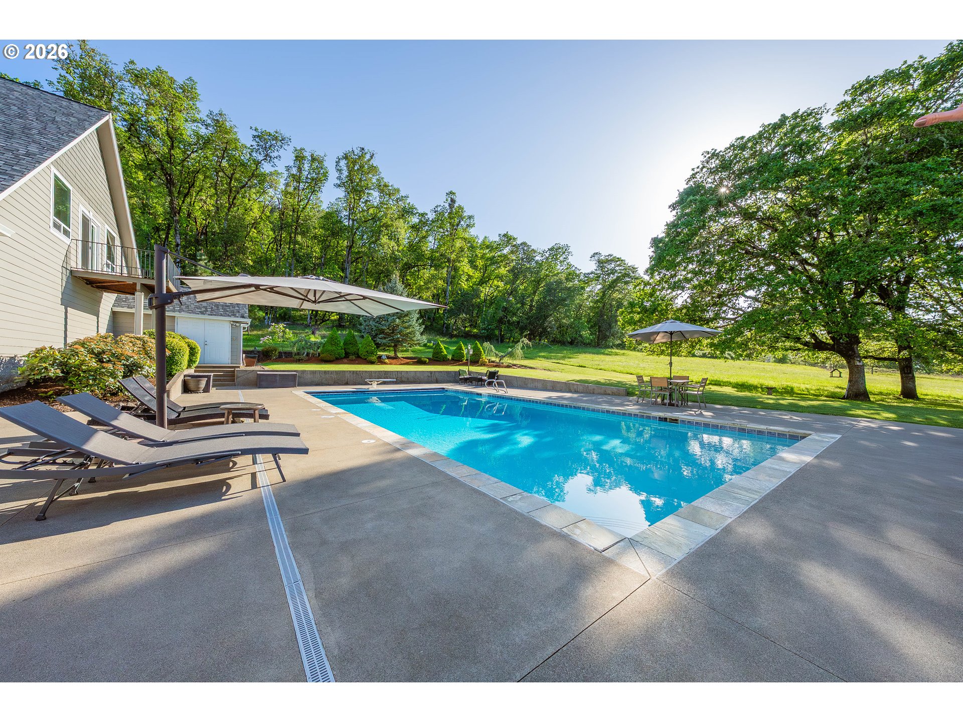 2700 Melrose Road Roseburg, OR 97471 - Photo 47 of 48 a view of a swimming pool with an outdoor space and seating area