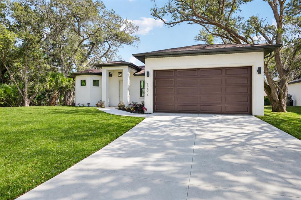 a front view of a house with a yard and garage