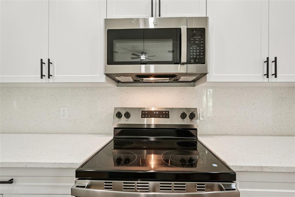 1852 Rada Lane North Port, FL 34288 - Photo 11 of 29 a stove top oven sitting inside of a kitchen
