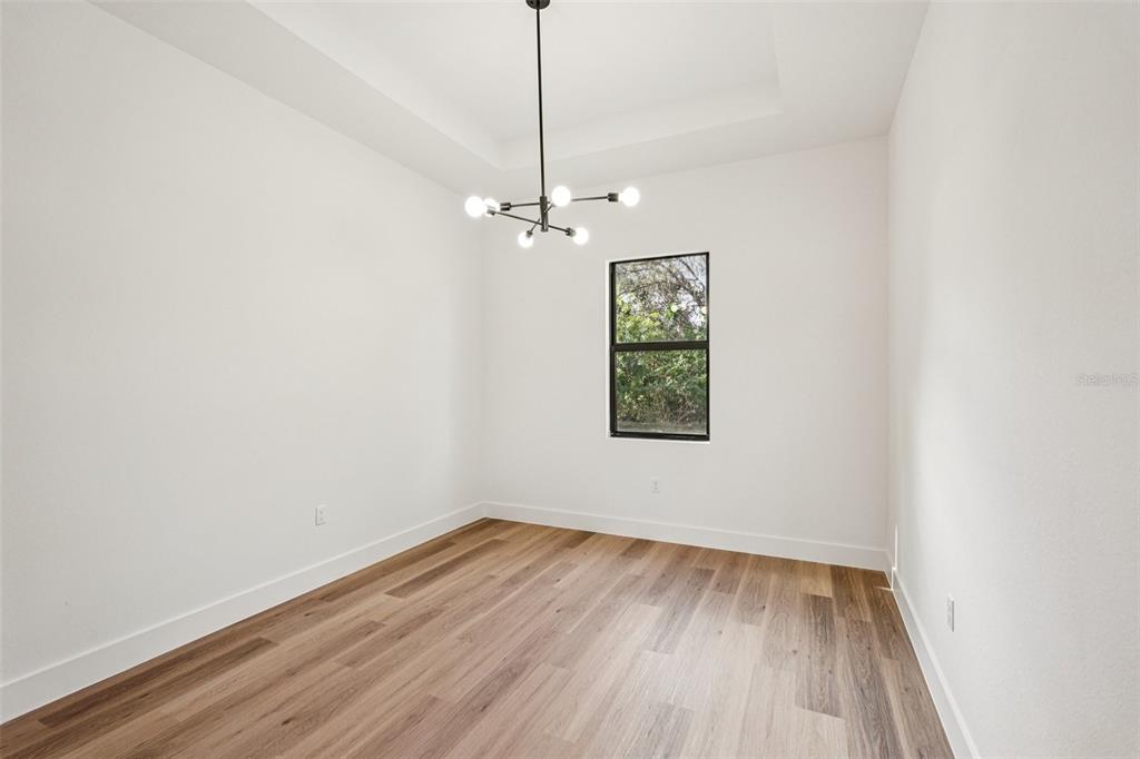 1852 Rada Lane North Port, FL 34288 - Photo 14 of 29 wooden floor in an empty room with a window