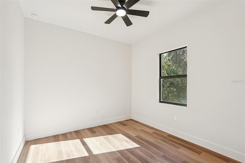 1852 Rada Lane North Port, FL 34288 - Photo 15 of 29 an empty room with wooden floor and windows