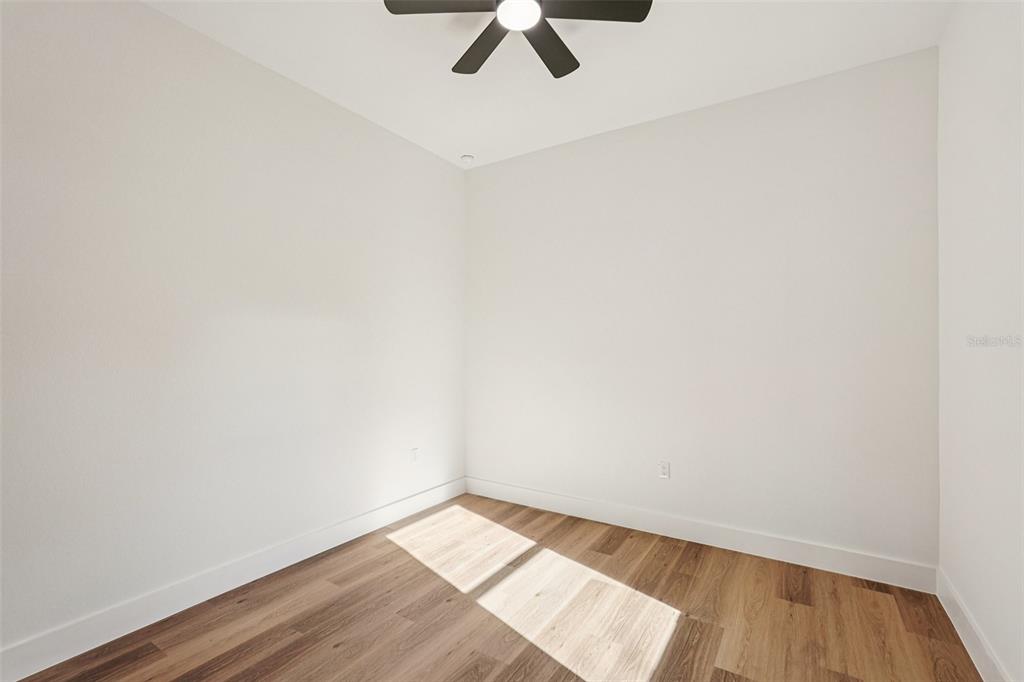 1852 Rada Lane North Port, FL 34288 - Photo 17 of 29 a view of an empty room with wooden floor and a window