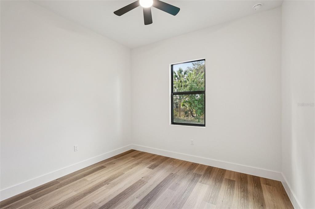1852 Rada Lane North Port, FL 34288 - Photo 20 of 29 an empty room with a window and wooden floor