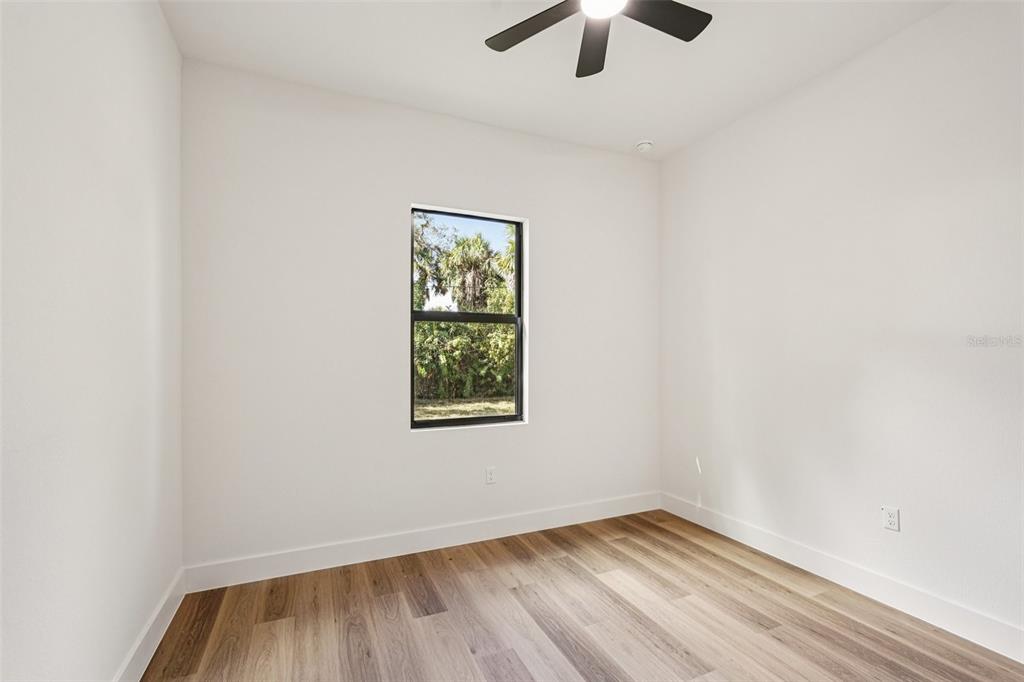 1852 Rada Lane North Port, FL 34288 - Photo 21 of 29 an empty room with ceiling fan and window