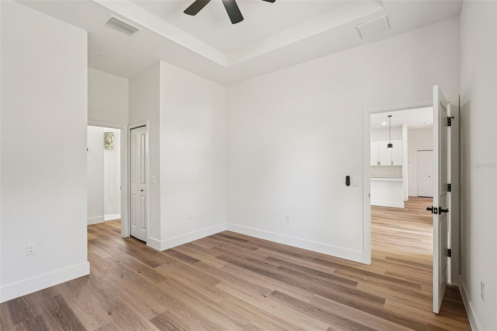 1852 Rada Lane North Port, FL 34288 - Photo 23 of 29 an empty room with wooden floor and a ceiling fan